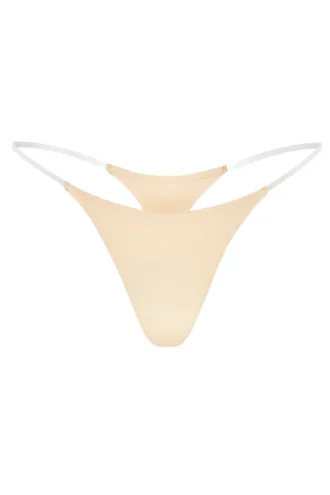 Intimates sømløs strikket tanga med gjennomsiktige stropper i varm fersken