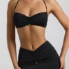 Jerika Slinky Jersey-bralette med metallbeslag og halterneck i svart