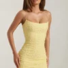 Lunetta pyntet bodycon-minikjole med rund hals i gult