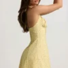 Nerine halterneck A-line minikjole i gult blomstertrykk
