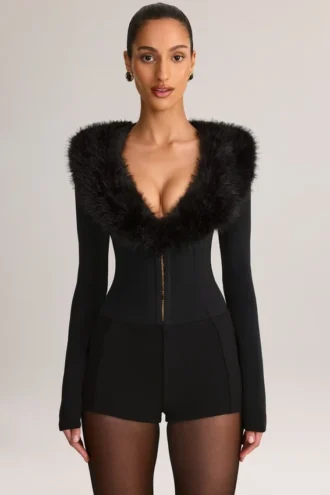Nesta korsett-playsuit med fuskepelskant i svart