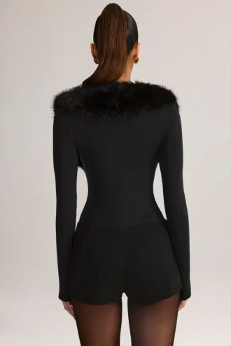 Nesta korsett-playsuit med fuskepelskant i svart