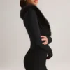 Nesta korsett-playsuit med fuskepelskant i svart