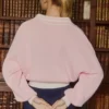 Oversized genser i bomullsjersey med V-hals i pudderrosa
