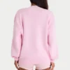 Oversized genser i ribbestrikk i blekrosa