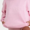 Oversized genser i ribbestrikk i blekrosa