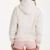 Oversized hettegenser med applikasjon i elfenben