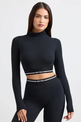 Ryggløs turtleneck-crop-top med lange ermer i svart