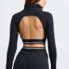 Ryggløs turtleneck-crop-top med lange ermer i svart