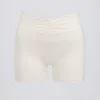 Rynket minishorts i elfenben melert