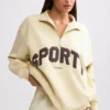 Sweatshirt med kvart glidelås i fargen Bone