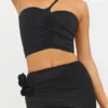 Tesia Slinky Jersey asymmetrisk topp med rosedetaljer i svart