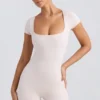 Unitard med rund hals i vasket kremfarge